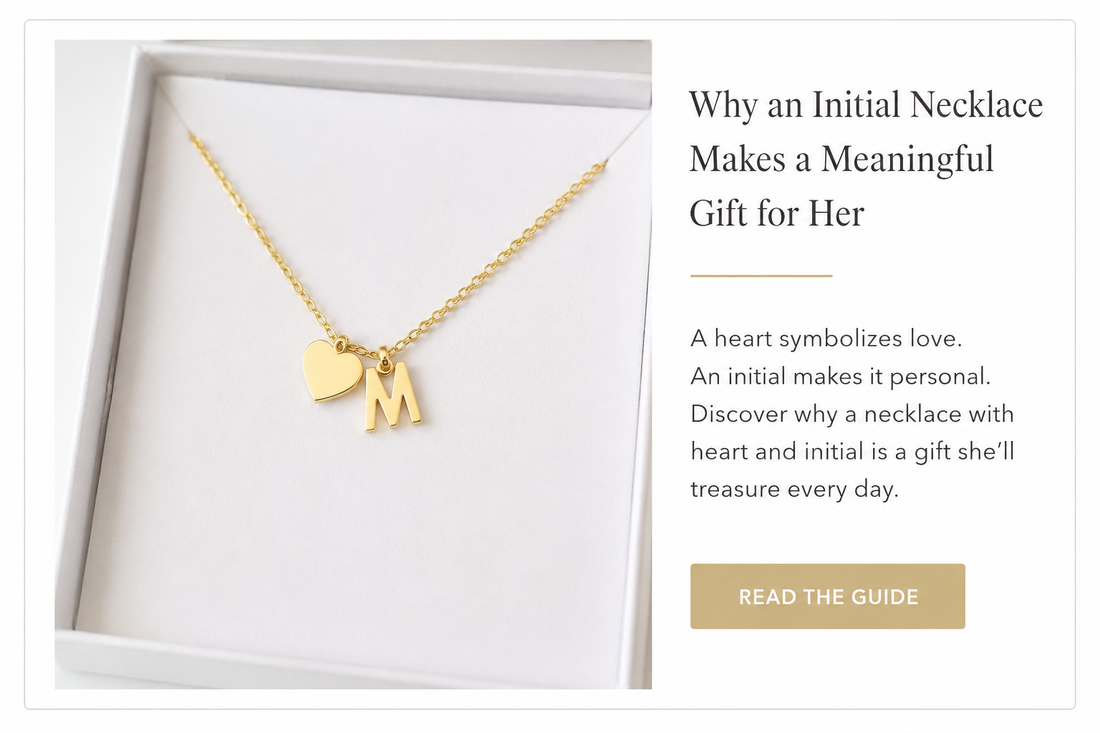 Gold necklace with heart and letter M initial displayed in a white jewelry box